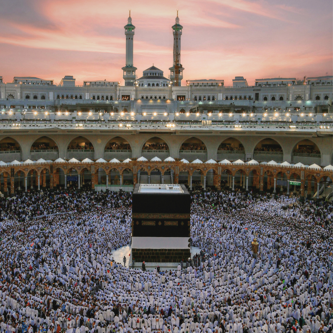 The Kaaba in Makkah at sunset during the first ten days of Dhul Hijjah, with pilgrims gathered in worship around the Sacred Mosque.