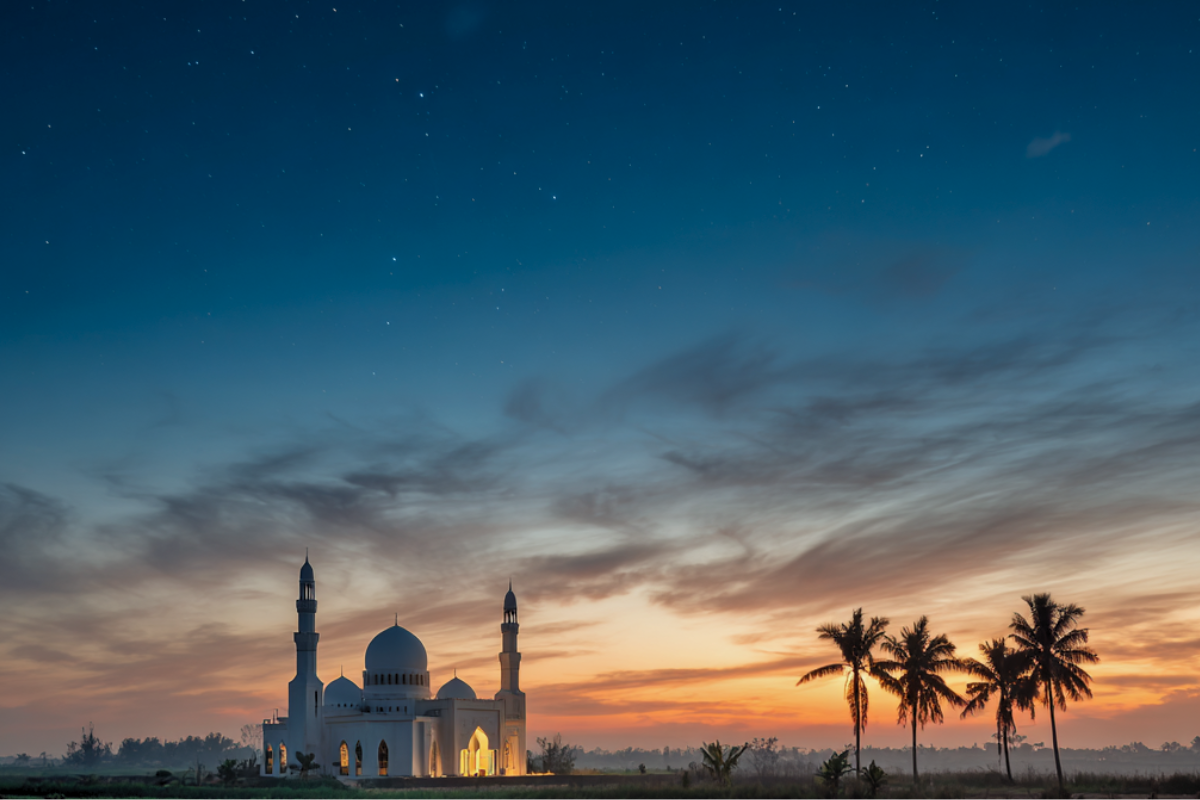 Crescent moon above a mosque at dusk symbolizing the sacred months in Islam